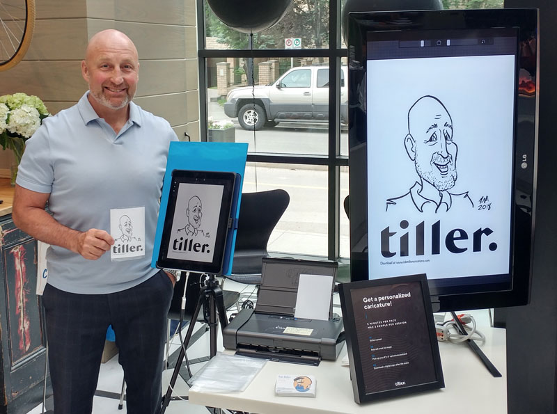 Man standing beside Digital Caricature screen with caricature printout at corporate event.