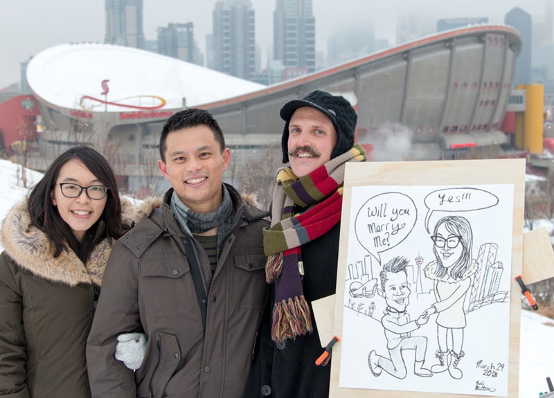 Engaged Couple with their proposal caricature and artist.