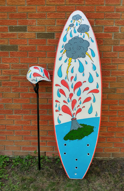 Surfboard and matching helmet with illustration of exploding volcano and storming clouds. 